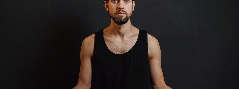 Person sitting in a calm meditative state before practice