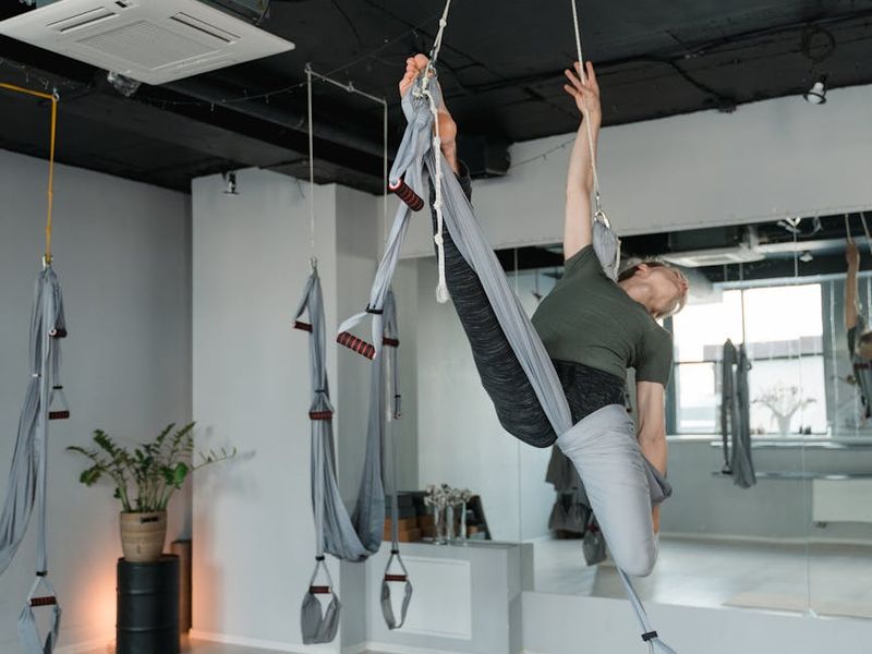 Wide shot of a minimalist yoga studio interior with mats
